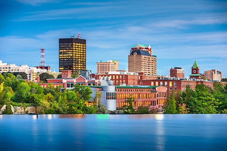 Manchester,,New,Hampshire,,Usa,Skyline,On,The,Merrimack,River,At Manchester NH skyline at dusk