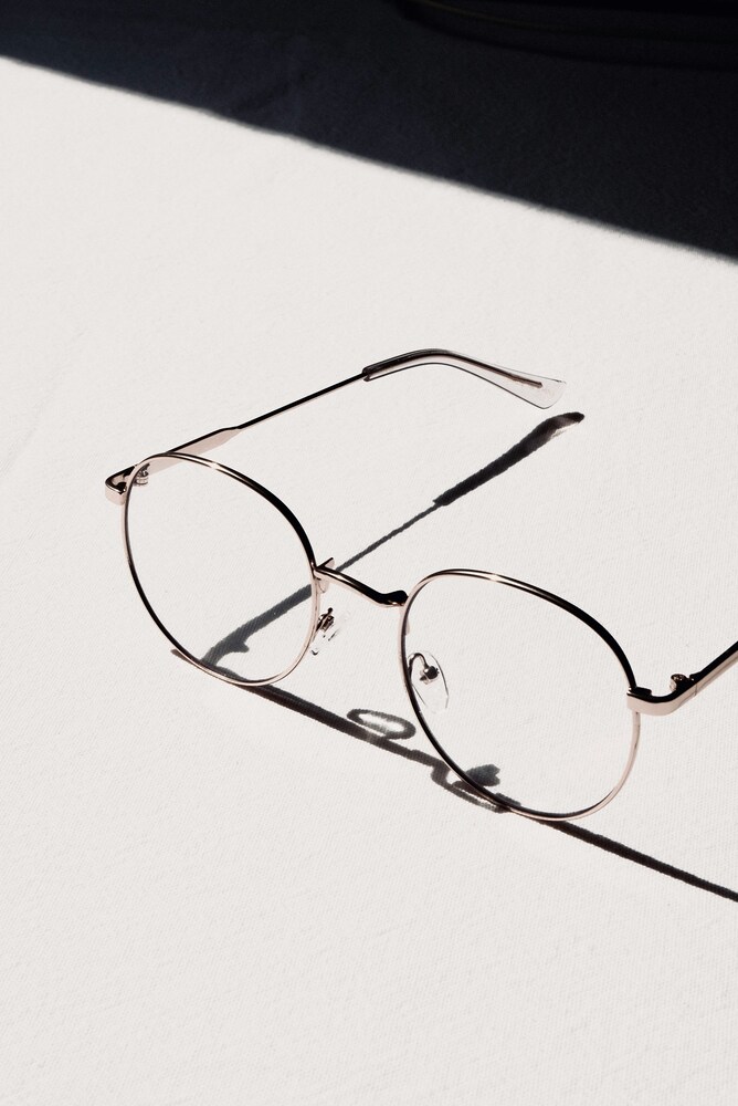 A sleek pair of lightweight round titanium frames repaired by professional frame repair