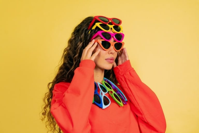 woman wearing multiple sunglasses