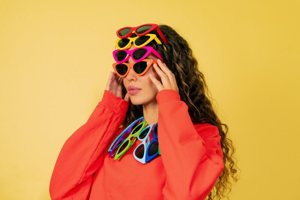 woman wearing multiple sunglasses woman wearing multiple glasses from different brands